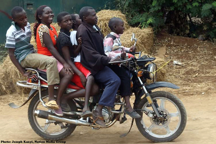 A boda boda rider carries five passengers in Kimbimbi Town, Kirinyaga County – Kenya 