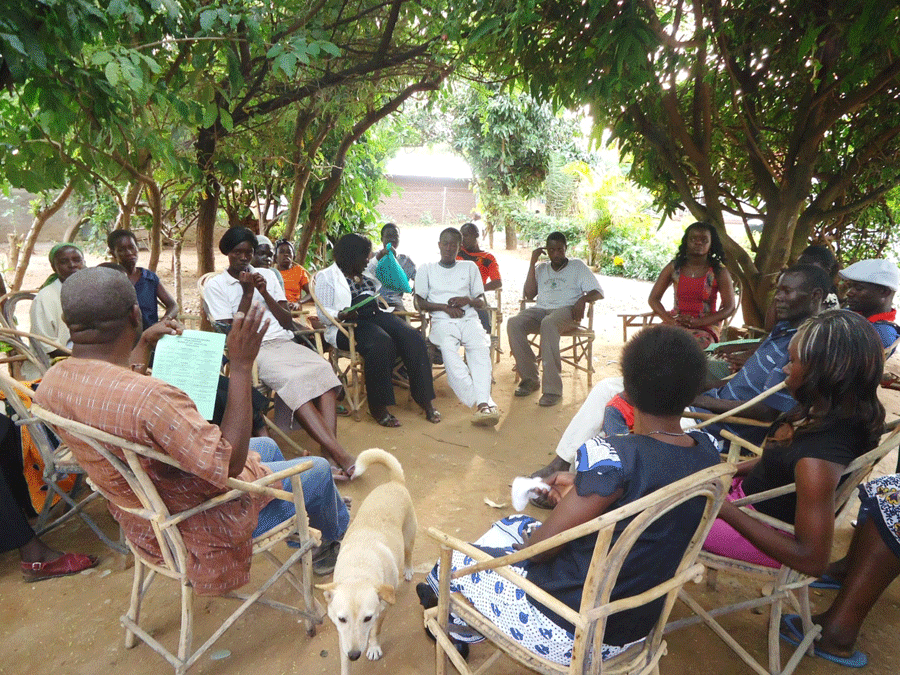 The author (with back to camera) having joint discussions with husbands and wives on development initiatives in Kajulu Location, Kisumu County - Kenya