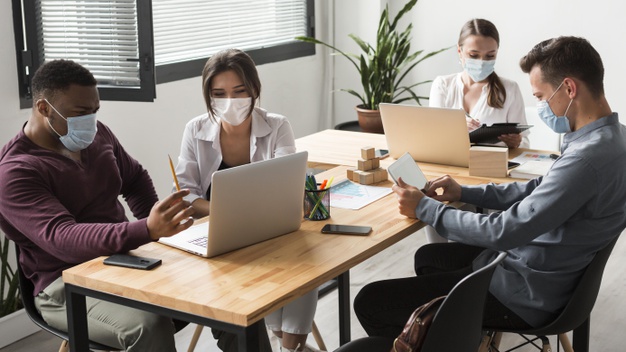 people during pandemic working together office with masks 23 2148666322