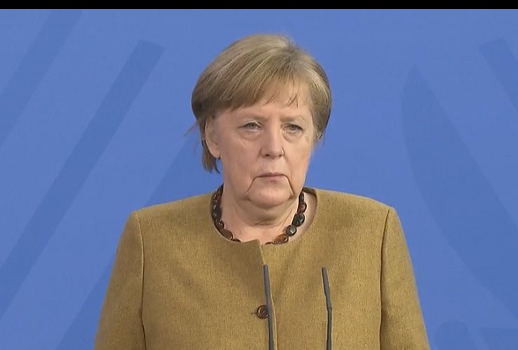 merkel in tan suit