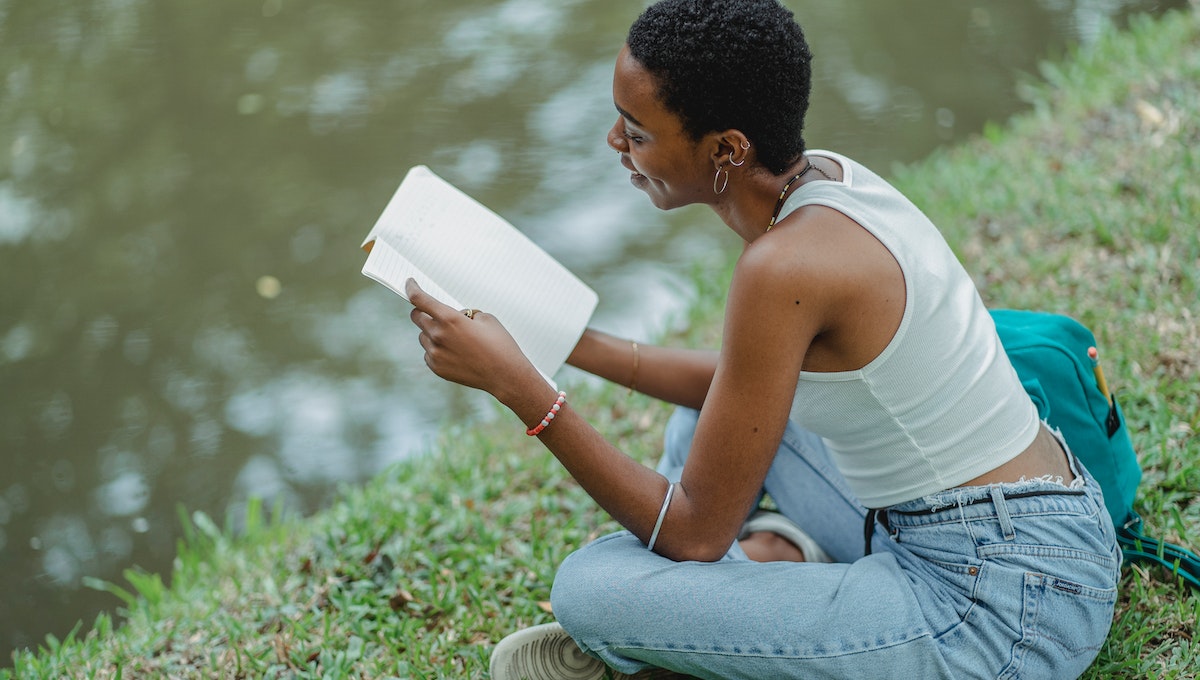 student reading by lake